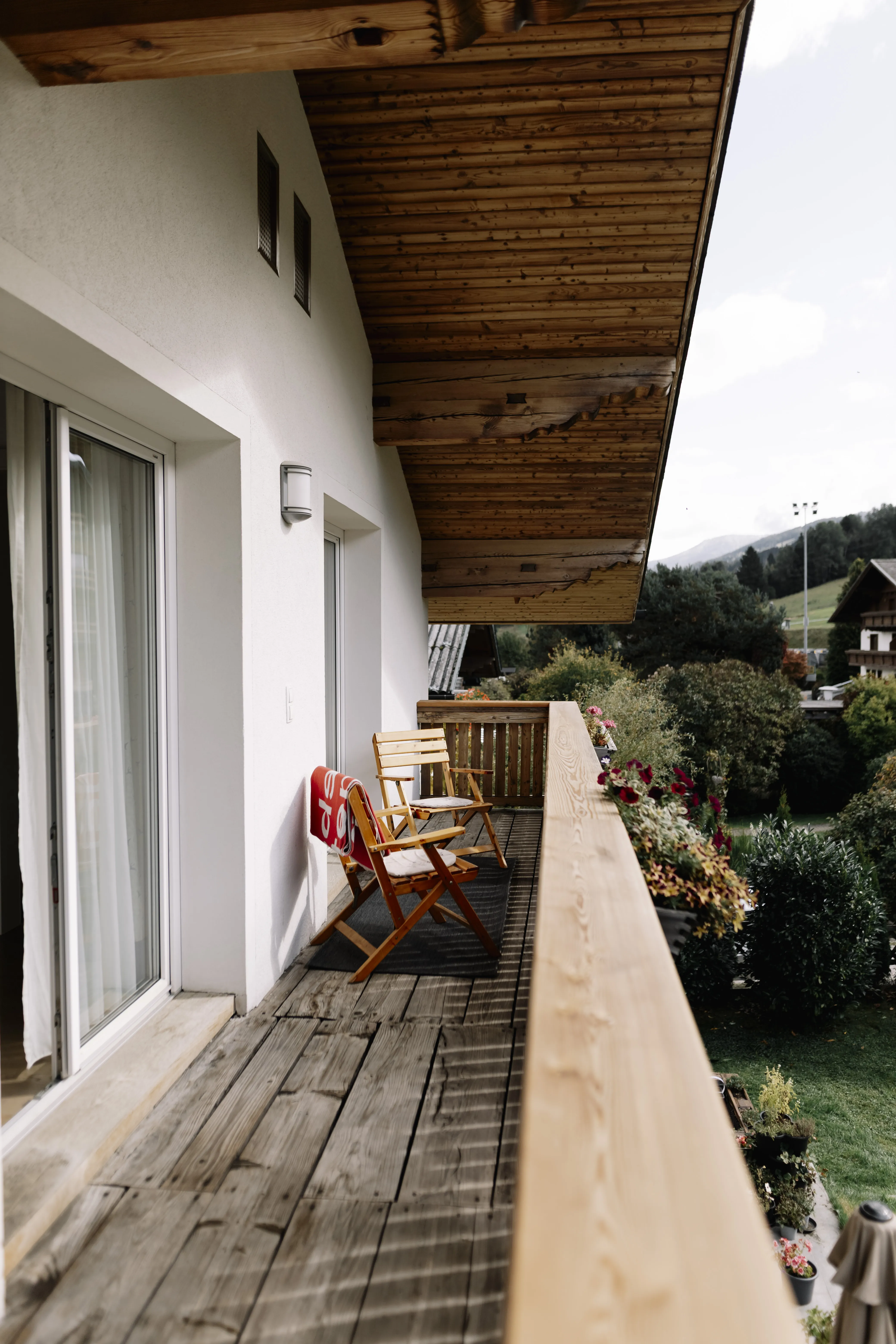 Haus Montis apartment living space with abundant natural light and mountain panorama